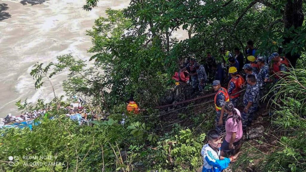 At least 14 killed after bus veers off road and plunges 150 metres down river bank in Nepal