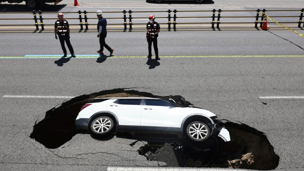 Elderly couple injured in South Korea after sinkhole swallows car