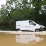 Cars submerged in water as some areas see more than a month’s rainfall