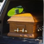 Body falls out of hearse in traffic