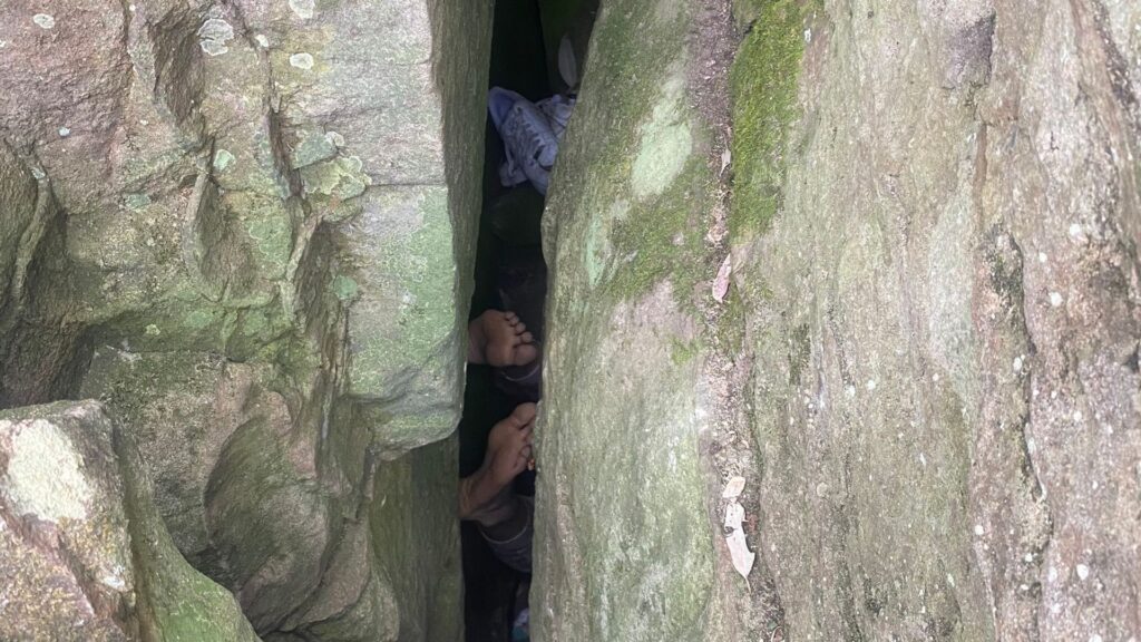 Woman trapped between boulders after trying to retrieve mobile phone from gap