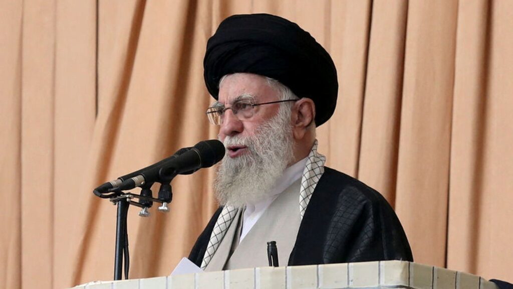 Iran’s supreme leader holds rifle as he issues warning about possible future missile attack