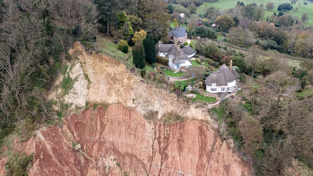 Cottage left teetering on cliff edge after massive landslip