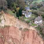 Cottage left teetering on cliff edge after massive landslip