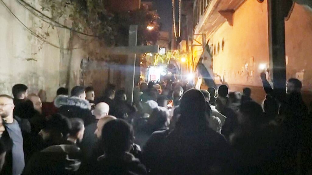 Protests break out as hooded fighters torch Christmas tree in Syria