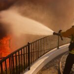 Film star helps firefighters battle LA wildfire sweeping exclusive hillside dotted with celebrity homes