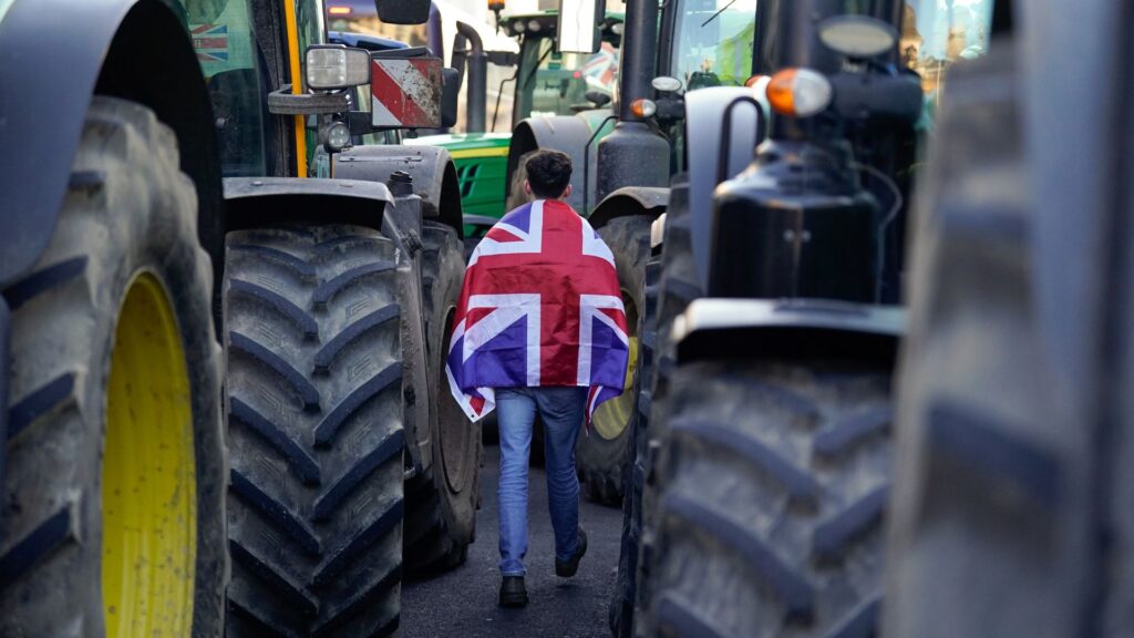 Environment secretary says ‘sorry’ to farmers over tax ‘shock’ – as noisy protest impacts speech