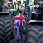 Environment secretary says ‘sorry’ to farmers over tax ‘shock’ – as noisy protest impacts speech