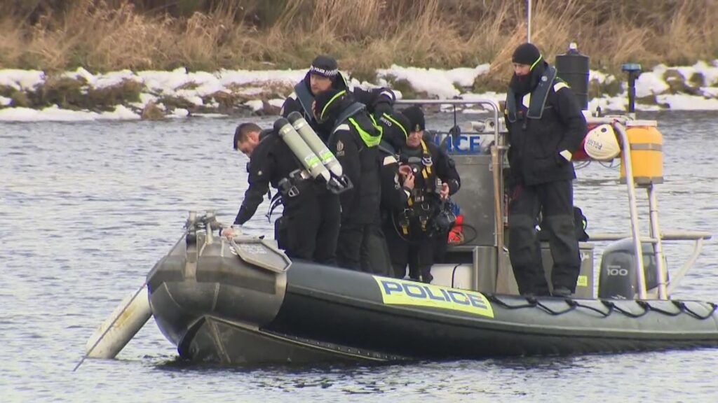 Police divers search river for missing sisters