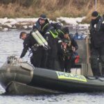 Police divers search river for missing sisters