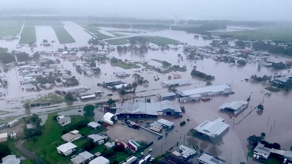 Woman dies and thousands urged to move to higher ground as ‘record-breaking rainfall’ hits Queensland