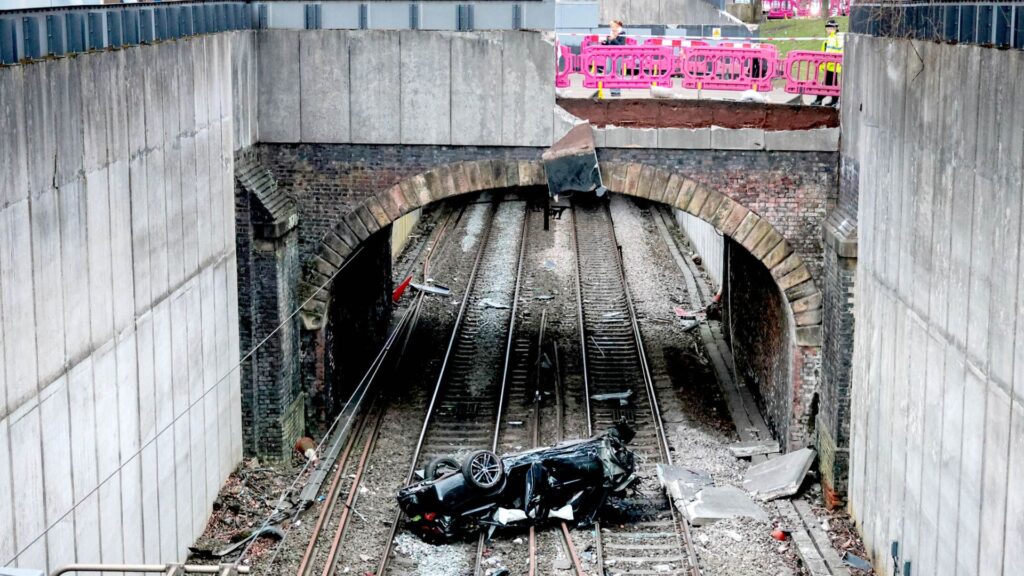 Driver arrested after car crashes onto railway lines