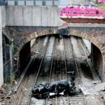 Driver arrested after car crashes onto railway lines